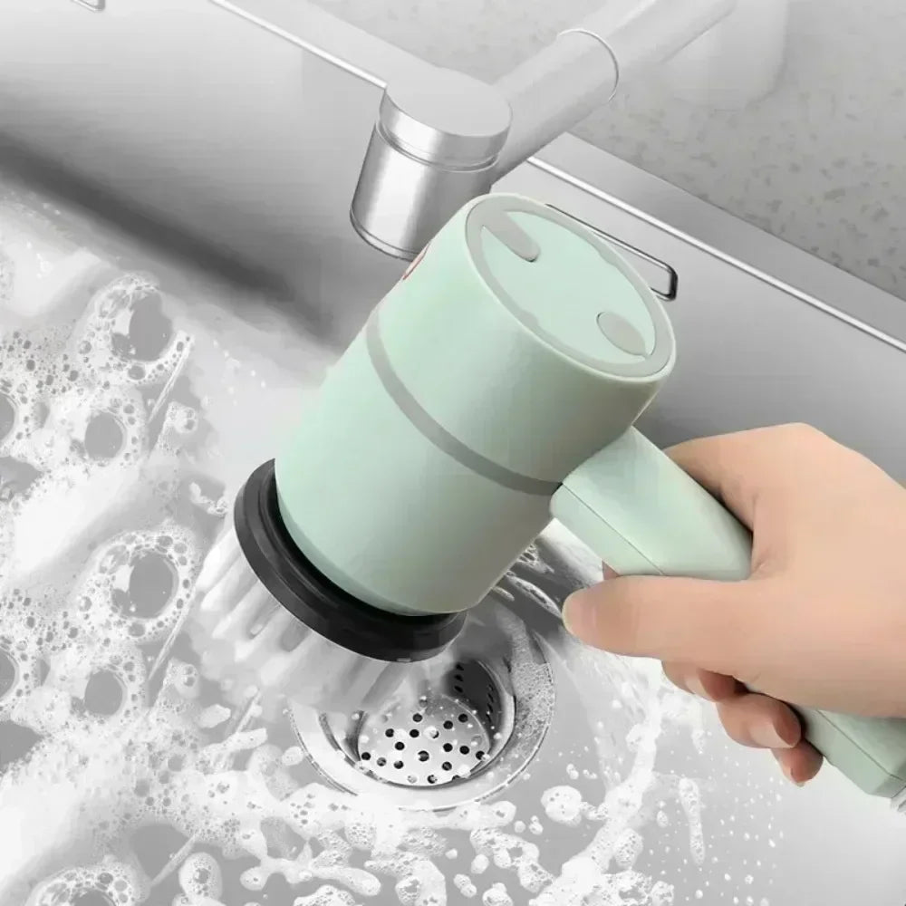 Handheld electric scrubber cleaning kitchen sink with soap and water